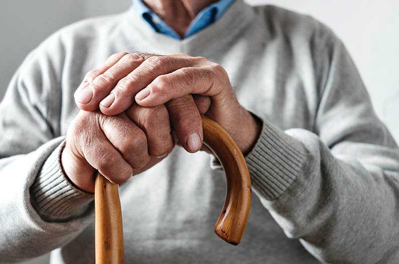 hands-elderly-man-resting-walking-cane copy